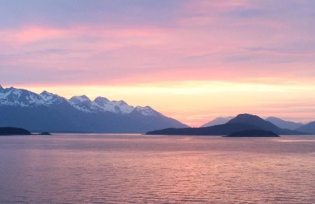 Mountains rising above a calm northern waterway