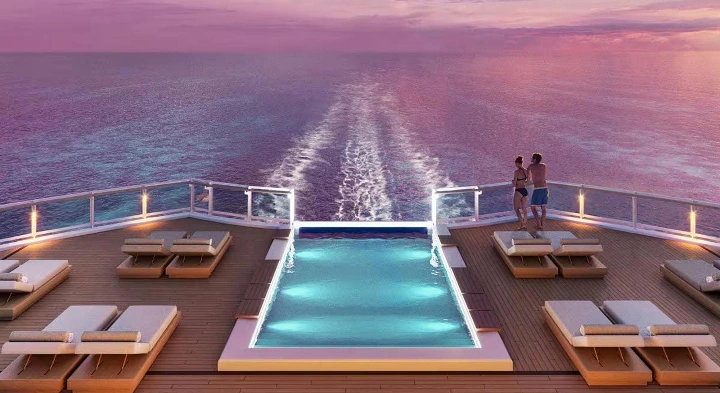 A tranquil ship's pool overlooking the ocean at sunset